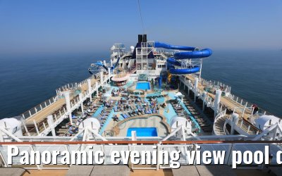 Panoramic evening view pool deck and waterslides Norwegian Bliss