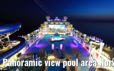 Panoramic view pool area Norwegian Bliss at dusk