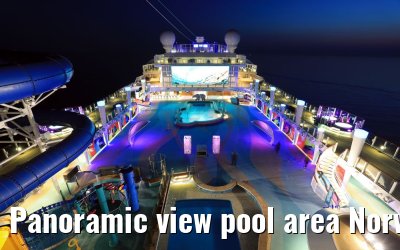 Panoramic view pool area Norwegian Bliss at dusk