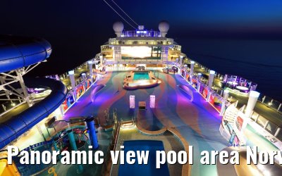 Panoramic view pool area Norwegian Bliss at dusk