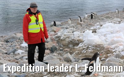 Expedition leader L. Feldmann and penguin Neko Harbor Antarctica 08.01.2017